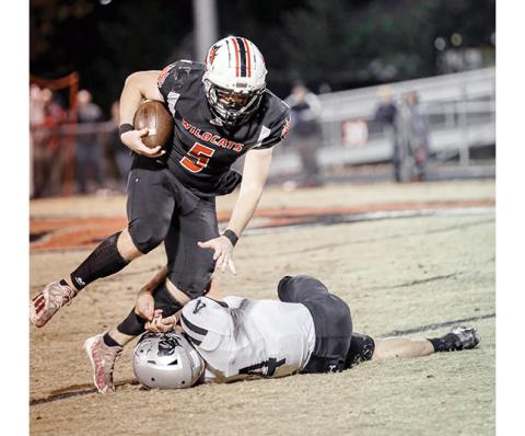 Haley Coffey/Contributing Photographer Andrews’ Austin Martin tries to shake off Robbinsville’s Cuttler Adams during the Wildcats’ 28-12 win over the Black Knights. Martin had 164 yards of offense and two touchdowns in the win, which was Andrews’ first over Robbinsville since 1998.