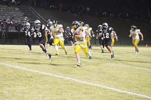 Justin Fitzgerald/sports@cherokeescout.com Murphy’s Hunter Stalcup runs away from the Robbinsville defense during the Bulldogs’ 48-16 win over the Black Knights on Friday night. Stalcup ran for a career-high 309 yards in the win, and Murphy had 533 yards of offense.