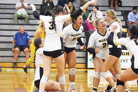 Justin Fitzgerald/sports@cherokeescout.com Murphy celebrates a game-winning kill by Julia Dockery (second from right) during its four-set win over Cherokee on Thursday.