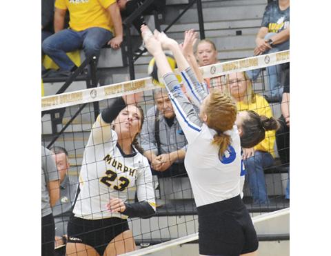 Justin Fitzgerald/sports@cherokeescout.com Murphy’s Liv Payne tries to hit the ball through the block of Cherryville’s Carson Reid (left) and Rileigh Kiser (right) during the Lady Bulldogs’ straight-set win over the Lady Ironmen on Saturday in the first round of the state playoffs.