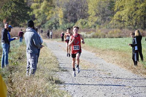 Justin Fitzgerald/sports@cherokeescout.com Andrews’ O’Malley Salinas sprints through the final stretch of the high school boys race during the Smoky Mountain Conference Championships on Saturday.