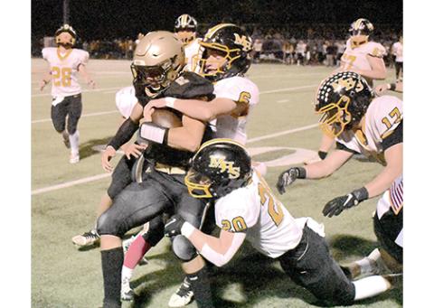 Gary Corsair/Clay County Progress Murphy’s Wyatt Simmons (6) and John Ledford (20) try to tackle Hayesville’s Logan Caldwell during the Bulldogs’ 21-14 win over the Yellow Jackets on Friday night.