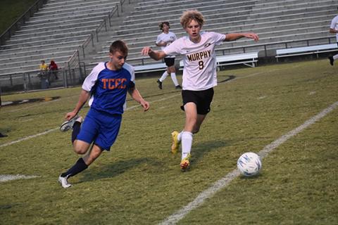 Justin Fitzgerald/sports@cherokeescout.com Tri-County’s Domenic Calascione (left) and Murphy’s Tyler Payne (right) battle for the ball during the Bulldogs’ 9-0 win over the Jaguars on Sept. 26.