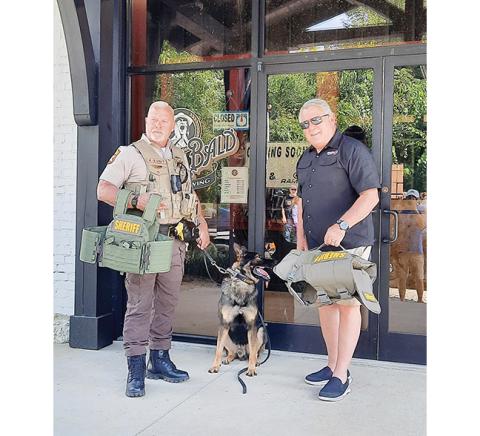 Photos by Bill Belian/Contributing Photographer  Dennis Dore and his K-9 partner each receive a ballistic vest as a donation from Michael Foreman with Point Blank Enterprises at Buck Bald Brewing.