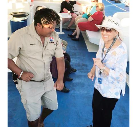 Ana Guiterrez, then 90, dances with a crew member on a family cruise.