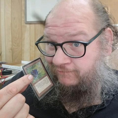 Anngee Quinones-Belian/Staff Correspondent  Matthew Stevens of Ranger holds a single “Magic the Gathering” card that is valued at $40,000. His ultimate goal is to create a virtual 3-D gaming platform in his yard for people to stop by and play games at his home.