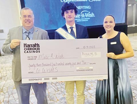 From left are Brooks Robinson, regional senior vice president & general manager of Harrah’s Cherokee Casinos; Cutter (the wish kid); and Heather Bertuccelli, director of corporate philanthropy for Make-A-Wish of Central & Western North Carolina.