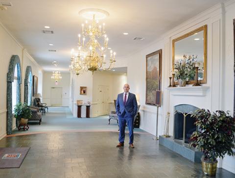 Abigail Blythe Batton/Staff Correspondent John Ivie prepares to welcome the bereaved inside Ivie Funeral Home in downtown Murphy.