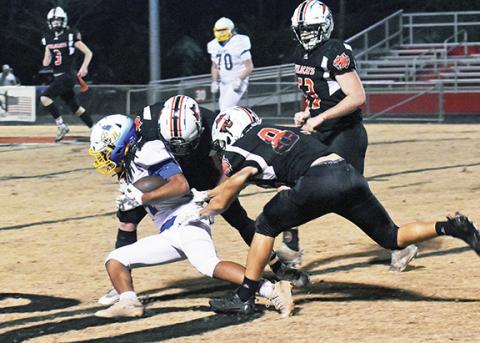 Photos by Justin Fitzgerald/sports@cherokeescout.com Andrews Isaac Weaver and Cole Anderson (85) team up to make the tackle on a Highland Tech ball carrier during the Wildcats’ 77-8 win over the Rams in the first round of the state playoffs Friday night.