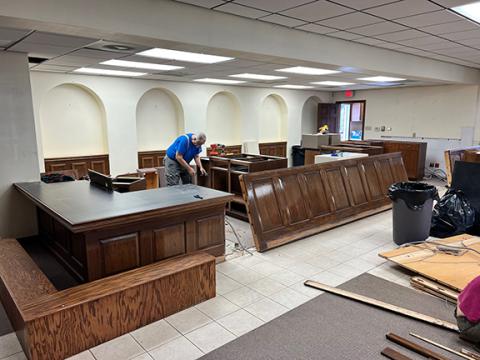 Tom Caley cuts out old teller stations at the Murphy Art Center’s new home in the former Entegra Bank building, 12 Peachtree St. on the square downtown.