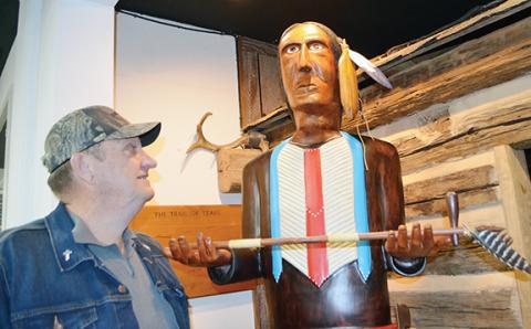 James Bryant stares up into the face of “Yellow Feather,” something he said was the hardest to sculpt. 