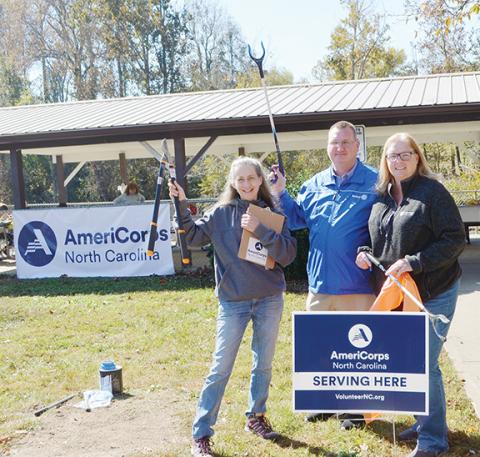 Photos by Abigail Blythe Batton/Staff Correspondent Katie Snow, program director with Project MARS; Mayor Tim Radford; and Susan Dean, AmeriCorps program director with Volunteer N.C. in Raleigh, pitch in Oct. 22 at Konehete Veterans Park during Make a Difference Day.