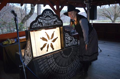 Abigail Blythe Batton/Staff Correspondent Katherine Fahey stands in front of her crankie art at John C. Campbell Folk School just before her show Oct. 31.