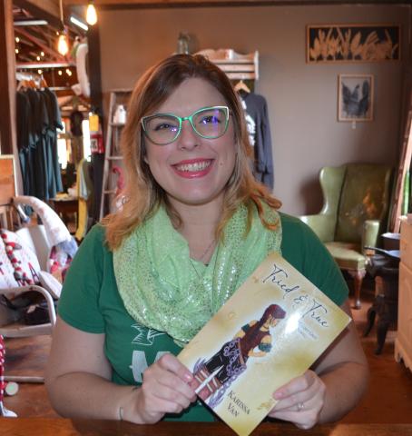 Abigail Blythe Batton/ Staff Correspondent Author Karrisa Van sits at the Rare Bird Emporium in Murphy with her new book, Tried and True, A Melody Grey Novel.