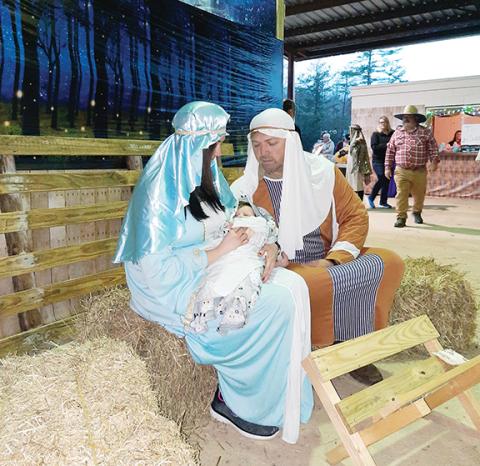 Photos by Anngee Quinones-Belian/Staff Correspondent  Julie, Steve and 3-month-old Angel Johnson played the roles of Mary, Joseph and baby Jesus. 