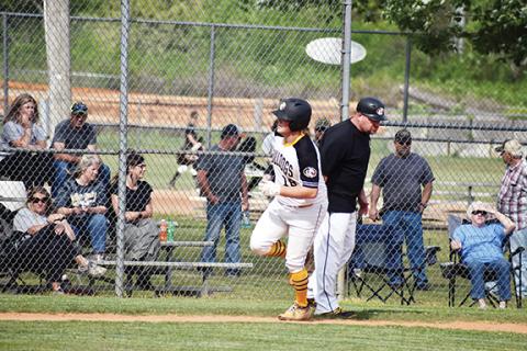 Justin Fitzgerald/sports@cherokeescout.com Murphy baseball coach Adam Clonts, shown moments after high-fiving Briggs Cornwell after he hit a home run, is stepping down after 10 years leading the Bulldogs.