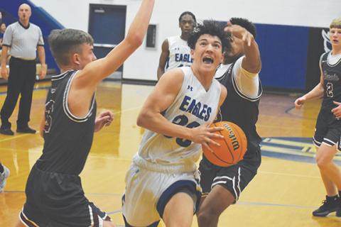 Justin Fitzgerald/sports@cherokeescout.com Hiwassee Dam’s Clay Davis drives through the lane during the Eagles’ 63-58 loss to Swain County on Friday.