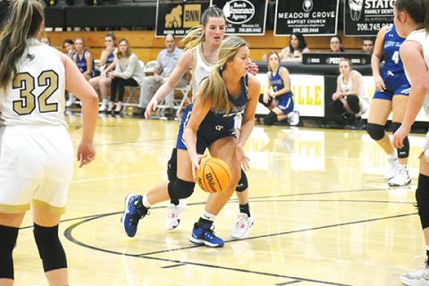Justin Fitzgerald/sports@cherokeescout.com Hiwassee Dam’s Olivia McNabb maneuvers around a Hayesville defender during the Lady Eagles’ 45-38 win over the Lady Jackets on Dec. 19. McNabb scored 14 points in the win.