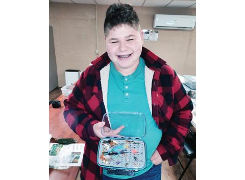 Photos by Anngee Quinones-Belian/Staff Correspondent  Eli Setless, 14, enjoys the class and tying flies.