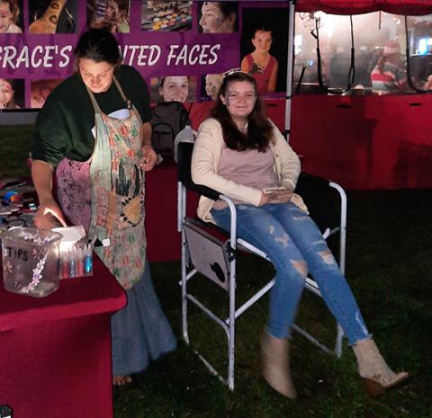Anngee Quinones-Belian/Staff Correspondent  Bailey Jones was happy to have her face painted by Grace’s Painted Faces during the Murphy Christmas Parade on Dec. 3.