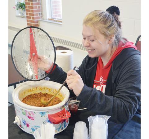 Photos by Abigail Blythe Batton/Staff Correspondent Patrisha Craft stirs her specialized chili at the annual Fire in the Valley chili cook-off at the Andrews Community Center on Saturday. 
