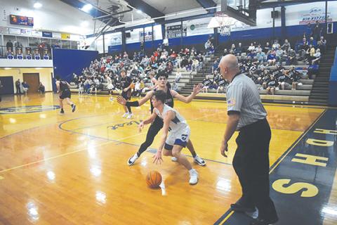 Justin Fitzgerald/sports@cherokeescout.com Andrews’ Donovan Bateman tries to cut off Hiwassee Dam’s Preston Hyde during the Wildcats’ 61-49 over the Eagles on Jan. 10.
