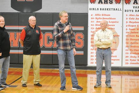Justin Fitzgerald/sports@cherokeescout.com Dr. Gary Roper (with microphone) addresses the crowd at the Ken Solesbee Athletic Center during his No. 15 jersey retirement ceremony Friday night. Roper’s jersey was retired in between the Andrews varsity girls and boys games against Cherokee.