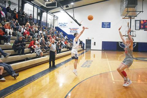 Justin Fitzgerald/sports@cherokeescout.com Hiwassee Dam’s Preston Hyde follows through on a 3-point shot during the Eagles’ 66-60 win over Copper Basin, Tenn., on Friday.