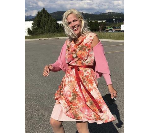 Abigail Blythe Batton happily swirling her layered print dress paired with authentic Western cowboy boots.