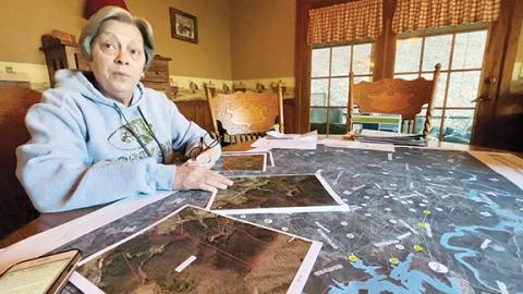 Randy Foster/editor@cherokeescout.com  Becky Wright has turned her dining room table into a project space in her fight against the Tennessee Valley Authority’s plans to install power transmission lines in western Cherokee County, including the Bell Hill Road property where she lives.