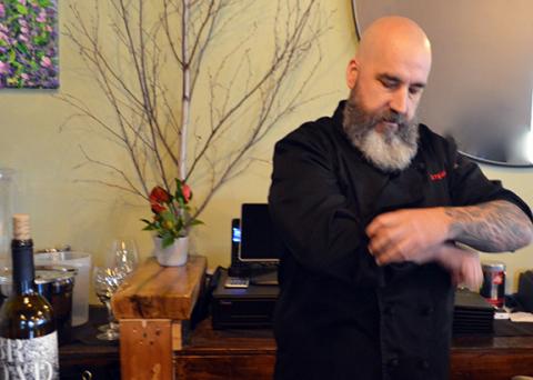 Abigail Blythe Batton/Staff Correspondent  Sage chef and owner Steven Lash rolls up his sleeves, preparing to work in his downtown Andrews restaurant, which is a tribute to his beloved father.