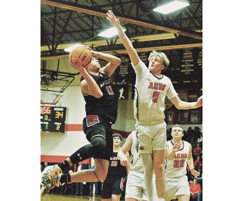Serena Smith/Avery Journal-Times Andrews’ Cam Rattler tries to maneuver a layup over the outstretched arm of Avery County’s Landon Ingham during the Wildcats’ 62-61 loss to the Vikings on Feb. 21