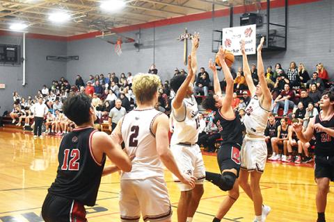 Justin Fitzgerald/sports@cherokeescout.com Andrews’ Cam Rattler battles in the post with Swain County’s Josiah Glaspie (left) and Aiden Southards (right) during the Wildcats’ 51-48 loss Friday night.