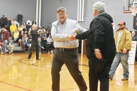 Justin Fitzgerald/sports@cherokeescout.com David Robinson, better known in the Andrews community as “Happy Jack,” shakes hands with Mayor James Reid during his induction to the Andrews High School Athletics Hall of Fame on Friday night.
