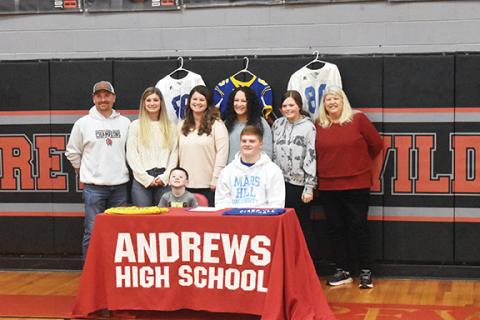 Justin Fitzgerald/sports@cherokeescout.com Andrews standout Isaac Weaver signed a National Letter of Intent to play football at Mars Hill University on Feb. 1. Pictured in the photo are (sitting) Weaver and his brother Blake (left); standing are Amos Weaver (father), Ashlyn Weaver (sister), Stephanie Weaver (mother), Alexis Finley (sister) Ava Pressly (cousin) and Kathy Pressley (grandmother).