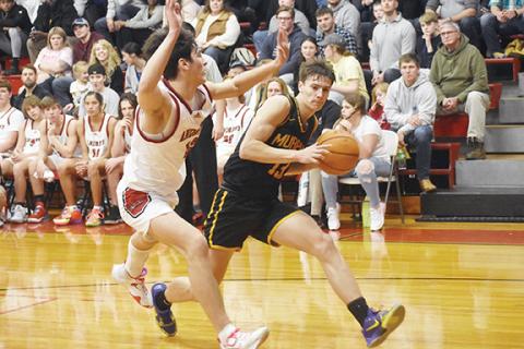 Justin Fitzgerald/sports@cherokeescout.com Murphy’s Zach Skogen tries to get by Andrews Donovan Bateman during the Bulldogs’ 69-50 win over the Wildcats on Friday.