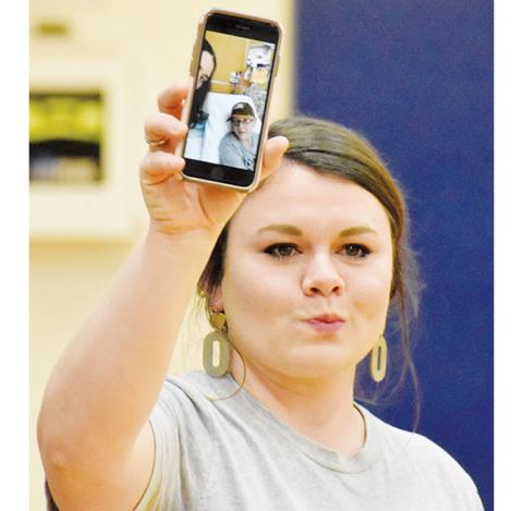 Kevin Hensley/The Graham Star Hiwassee Dam exceptional needs teacher Ashley Rhodes made an emotional FaceTime call so Eli Jones and his mother, Betty Jean Jones, were able to see the community support that poured into the high school’s gymnasium on Jan. 30. Various fundraisers throughout the evening’s Robbinsville vs. Hiwassee Dam games raised $5,324.25 for Eli, who is dealing with serious medical issues. The statement read that night is below.