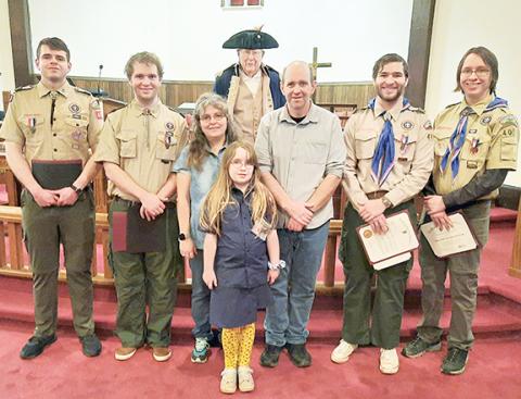 Anngee Quinones-Belian/Staff Correspondent  McCray brothers of Andrews receive recognition from the Sons of the American Revolution and Military Order of the World Wars, presented by Compatriot Ronald Hill on Saturday. Hill, wearing a Revolutionary War uniform, poses with (from left) Billy, Gilbert, Tina, Anthony, Larry and Elijah McCray. In front is Hannah McCray.