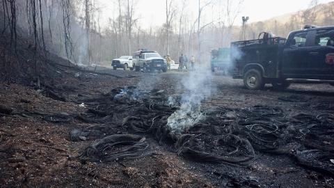 Firefighters gather near the source of a fire near Granny Squirrel on Thursday.