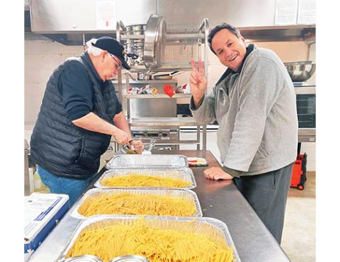 John Morton (left) and Chef J.P. serve up nutritious meals for homeless and lonely folks who stop by Soul Table at Murphy First United Methodist Church on the first Thursday of each month