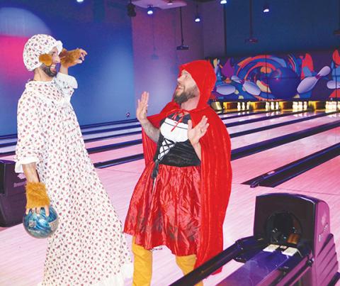 Photos by Abigail Blythe Batton/Staff Correspondent    Jai Beasley (Little Red Riding Hood) and Joe Simon (The Big Bad Wolf posing as Grandma) ham it up at the Big Brothers Big Sisters of Western North Carolina fundraiser Saturday at the UltraStar Multi-tainment Center inside Harrah’s Cherokee Valley River Casino & Hotel. 