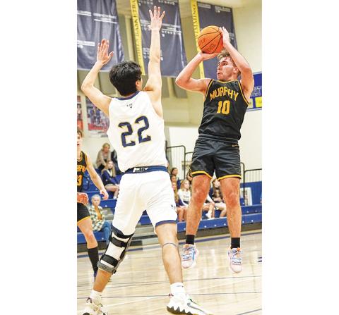 Charles Bilcoinish/Contributing Photographer Murphy’s Dillian Brown rises for a jumper during the Bulldogs’ 80-49 loss to Bishop McGuinness during the second round of the state playoffs Thursday night.