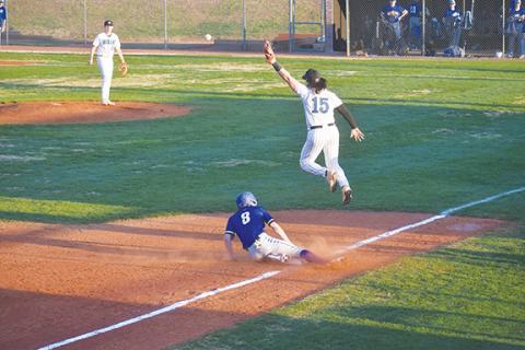 Justin Fitzgerald/sports@cherokeescout.com Hiwassee Dam’s Clay Davis slides into third base as the throw gets over the head of Towns County’s Stone Chauncey during the Eagles’ 13-3 loss to the Indians on March 7.