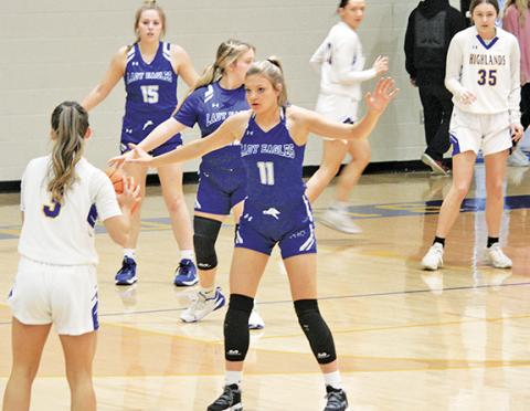 Ryan Hanchett/sports@The Highlander Hiwassee Dam’s Katie McNabb plays defense on Highlands’ Beatrice Bryson during the Lady Eagles’ 43-36 loss to the Lady Highlanders in the first round of the NCHSAA playoffs on Feb. 23.