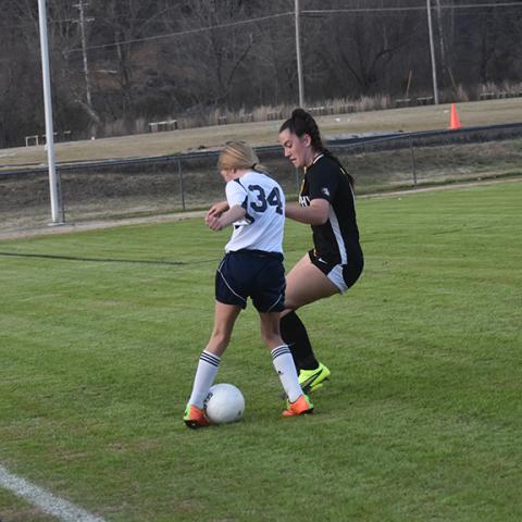 Justin Fitzgerald/sports@cherokeescout.com  Murphy’s Catalina Barreiro battles with a Summit Charter player for the ball as head coach Kim Brownlee watches during the Lady Bulldogs’ 6-2 loss to Summit Charter on March 6. 