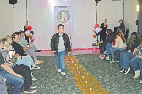 Abigail Blythe Batton/Staff Correspondent Joe Averaino walks the runway with an attitude at the Wear the Care Fashion Show held March 6 to raise money and awareness for Reach of Cherokee and Graham Counties Inc.