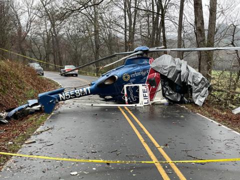 Wreckage of Life Force 6 blocks Middle Burningtown Road in Macon County on Friday on the morning following a crash. All four aboard survived.