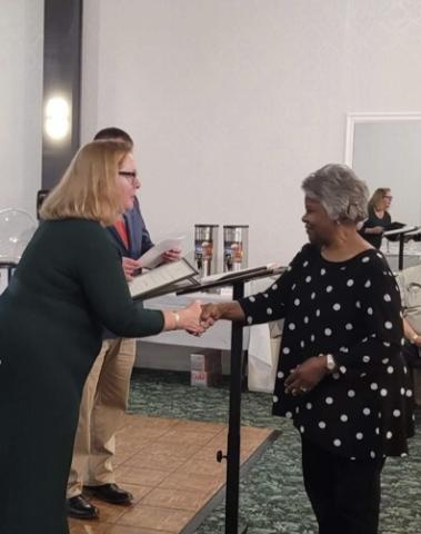 Brenda Blount (right) receives her award from Susan Dean, AmeriCorps program coordinator, for Person of the Year in Texana on March 25 at The Ballroom in Murphy. The event honored 37 local volunteers.
