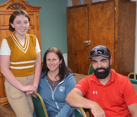 Photos by Abigail Blythe Batton/Staff Correspondent Elsa Holland, second-place winner in the Tri-County Democratic Women’s Club essay writing contest, stands with her mom, Melissa Burchfield, and dad, Chris Holland, at the award’s ceremony April 17 at Penland Senior Center.