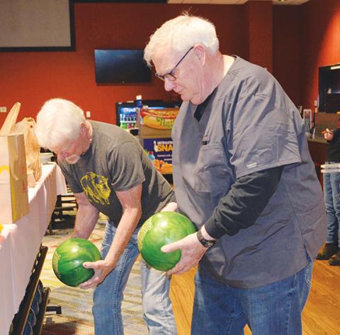 Photos by Abigail Blythe Batton/Staff Correspondent John Morton and Rick Alringer choose balls before bowling March 25 at the UltraStar Multi-tainment Center inside Harrah’s Cherokee Valley River Casino & Hotel to benefit Big Brothers Big Sisters of Western North Carolina. Both men represented team ‘Water Buffalos’ from First United Methodist Church in Murphy. ‘We named ourselves after the Sacred Order of the Water Buffalos from the Flintstones,’ Morton said by way of fun explanation. Read the article in th